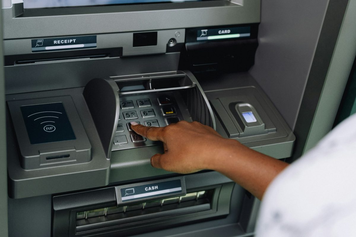 A person using an ATM keypad