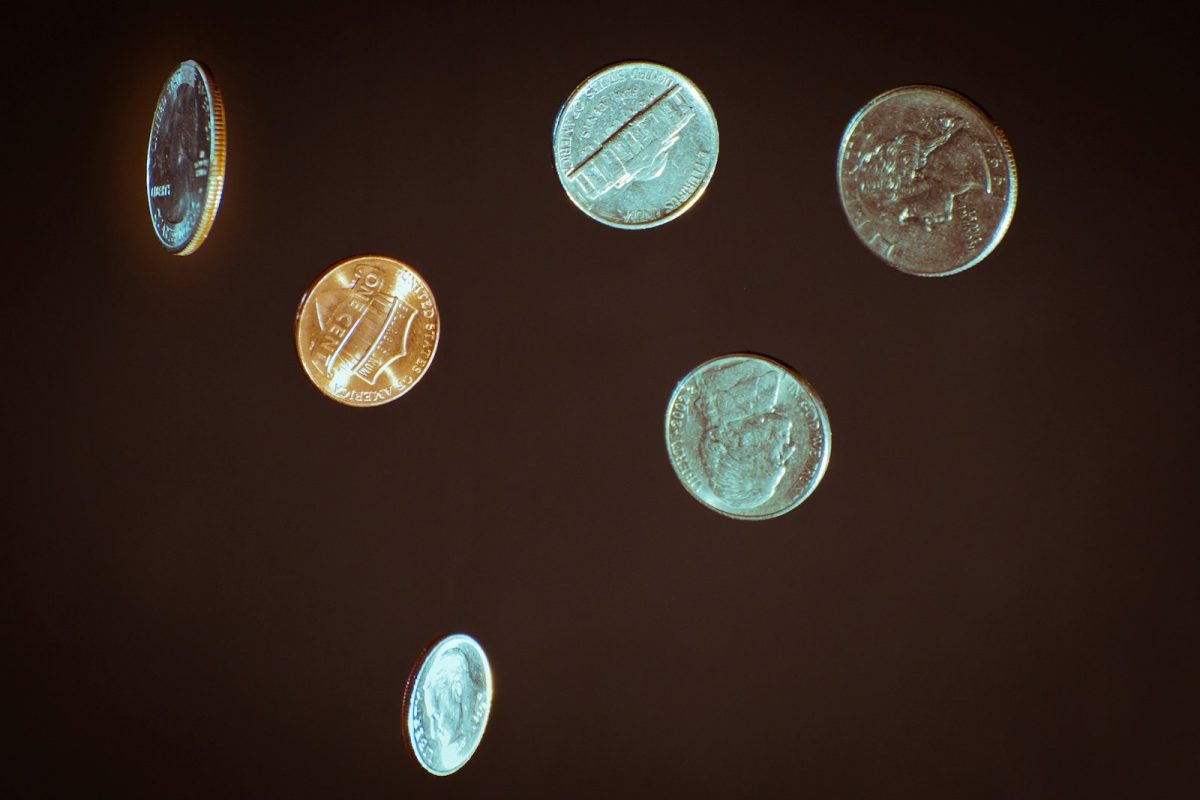 U.S. coins scattered on a dark surface