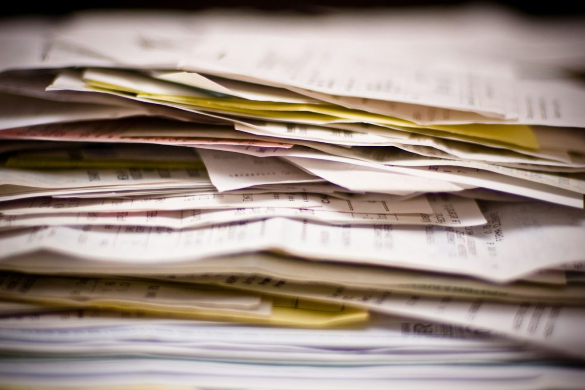 A close-up of a stack of papers and statements